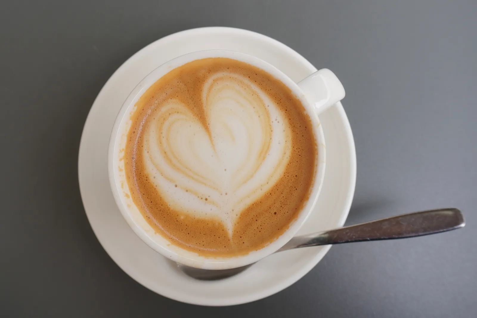 Two cups shared across a small café table.